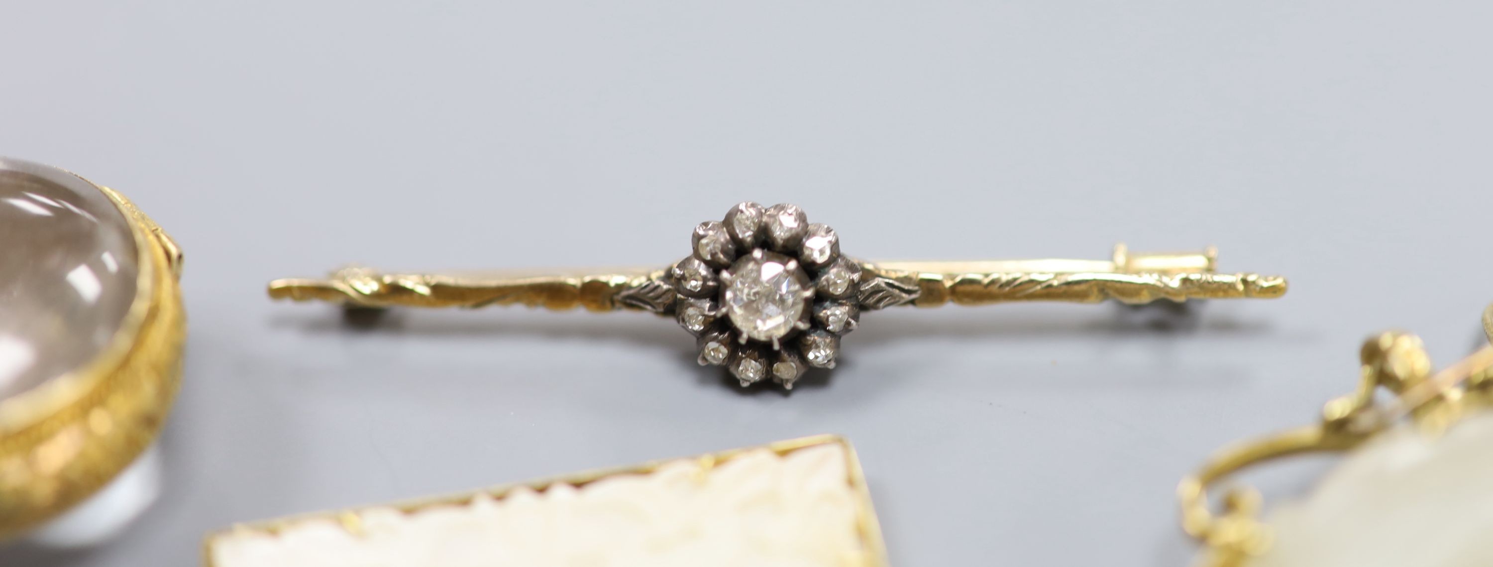 An early to mid 20th century 585 and 925, diamond cluster set bar brooch, 53mm, gross 3.7 grams, a 9ct gem set ring and three mounted pendant including one stamped 14k.